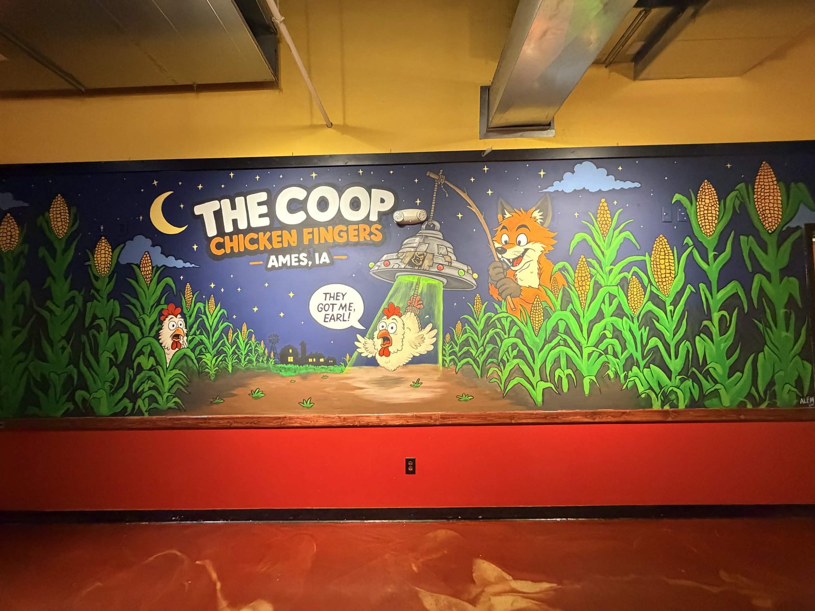 The Coop Chicken Fingers mural seen straight on, showing the fox, the abducted chicken and the restaurant name