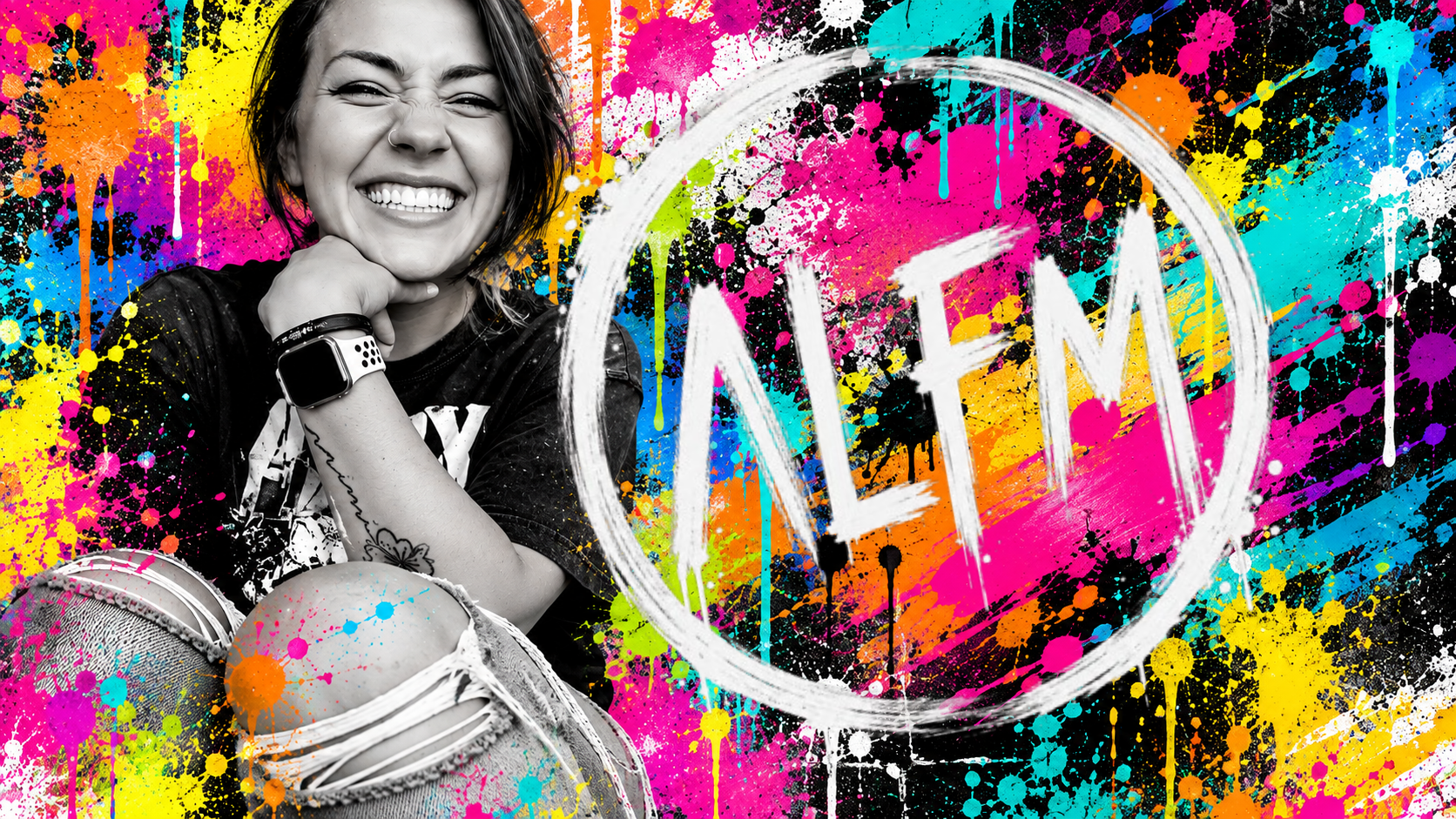 Amanda Fatino laughing in front of a colorful paint splatter backdrop with the ALFM logo