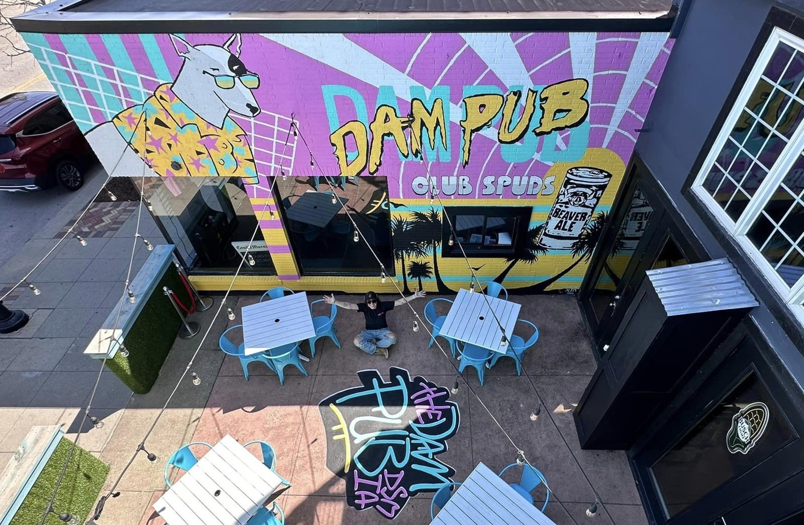 Aerial view of the Dam Pub mural with the painted patio floor art