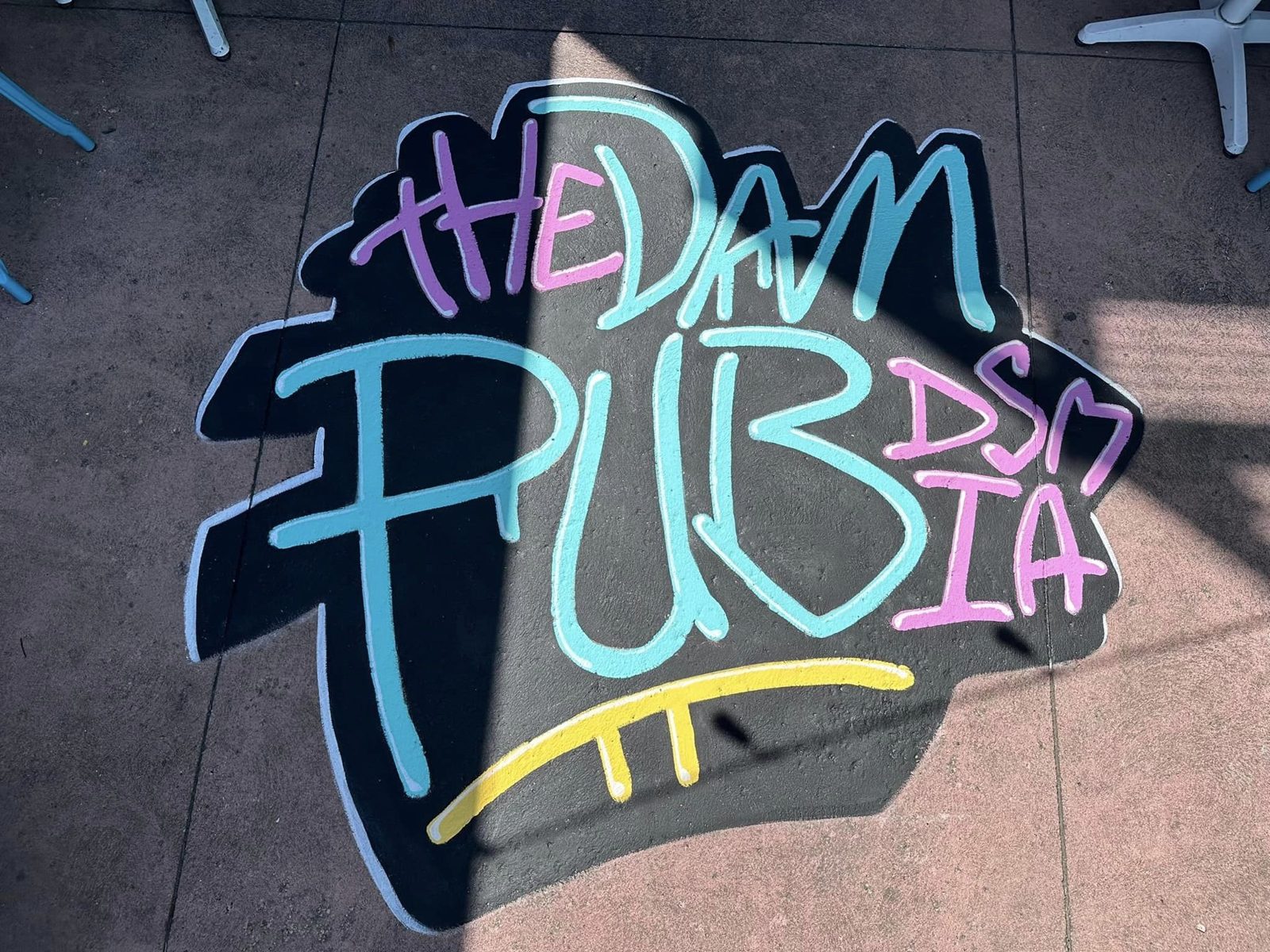 The Dam Pub DSM IA painted floor logo on the patio