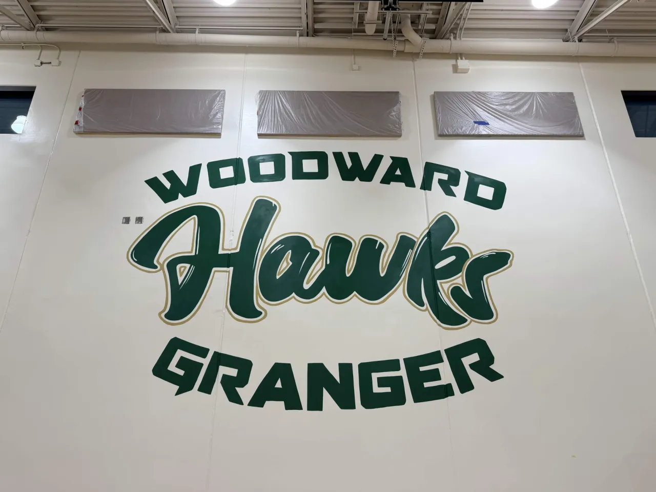 Close view of the Woodward Granger Hawks lettering: WOODWARD arched above, Hawks in script, GRANGER curved below